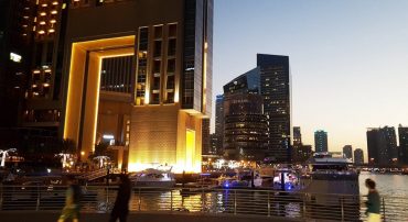 People walking on Dubai Marina in the evening